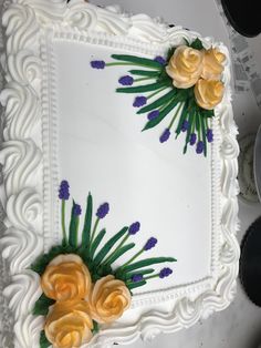 a white cake with yellow and purple flowers on it