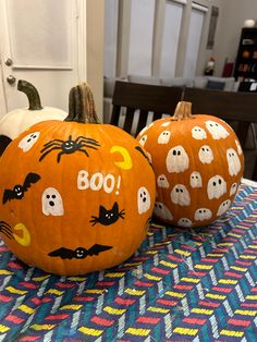 two decorated pumpkins sitting on top of a table