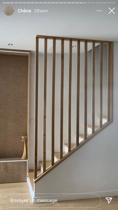 an empty room with wooden stairs and beige blinds on the wall, in front of a mirror