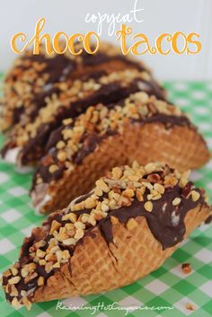 chocolate tacos with nuts on top are sitting on a green and white checkered tablecloth