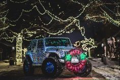 the jeep is decorated with christmas lights and decorations