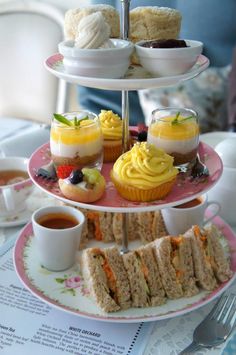 three tiered tray with cupcakes, muffins and tea on it