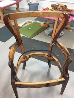 an old wooden chair is being worked on