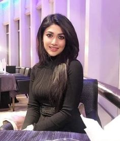 a woman sitting at a table in a restaurant