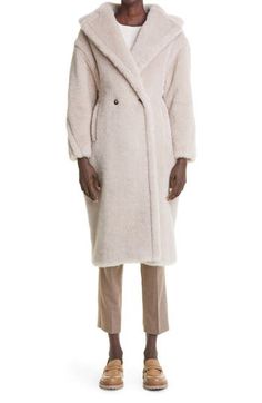 Dropped shoulders and angled-forward sleeve seams augment the oversized, cocoon-like shape of this statement coat, enveloping you in luxe softness and warmth. 40 1/2" length Double-breasted button closure Notched lapels Side-seam welt pockets Lined 62% alpaca, 26% virgin wool, 12% silk Dry clean Made in Italy Women's Designer Clothing Luxury Oversized Long Sleeve Outerwear, Luxury Oversized Wool Coat With Long Sleeves, Chic Oversized Long Sleeve Fur Coat, Max Mara Alpaca Coat, Max Mara Cashmere Coat, Max Mara Teddy Bear Coat, Cozy Alpaca Outerwear, One Size, Max Mara Coat 101801, Statement Coat