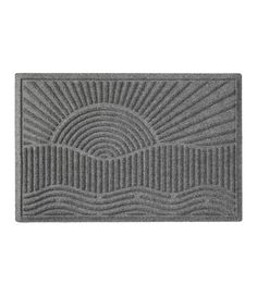 a blue door mat with wavy lines on the front and center, in an oval pattern