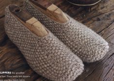 a pair of slippers sitting on top of a wooden table