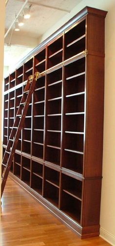 a ladder leaning against a bookcase in an empty room