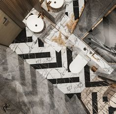 an aerial view of a bathroom with marble flooring and black and white tiles on the walls