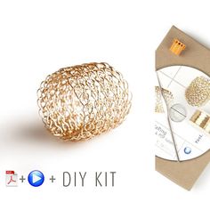 the gold wire ball is next to an envelope with cd's and dvd's on it