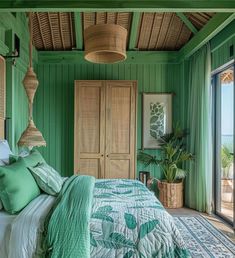 a bedroom with green walls and bedding in the center, along with wicker hanging from the ceiling