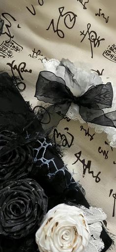 black and white fabric with lace flowers on it's edges, including one in the middle