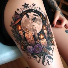 a woman's thigh with candles and stars in the moon tattoo design on it