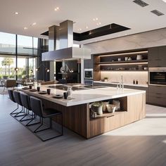 a large kitchen with an island in the middle and lots of counter space on one side