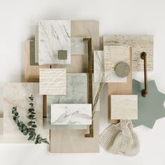 an assortment of marble and wood pieces arranged on top of each other, including a plant