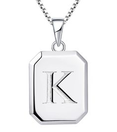 a pendant with the letter k on it's front and back sides, hanging from a