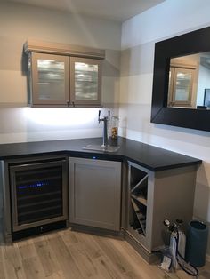 a kitchen with a wine cooler in the corner