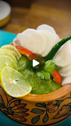 a bowl filled with ice cream and limes