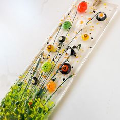 an art piece made out of glass with flowers on it