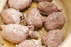 meatballs are being cooked in a pot on the stove