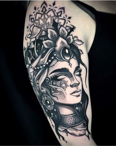 a woman's arm with tattoos on it and an image of a flower in the middle