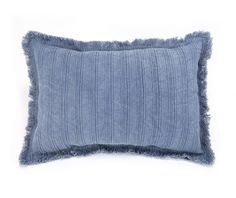 a blue pillow with fringes on the front and back, against a white background