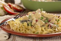 a plate of pasta with chicken and vegetables