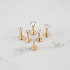 four pairs of gold plated studs with crystal stones