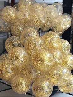 gold and white balloons are stacked on top of each other