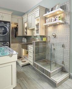 a kitchen with a sink, washer and dryer in it's center