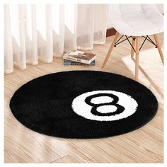 a black and white rug with the number eight on it in front of a chair