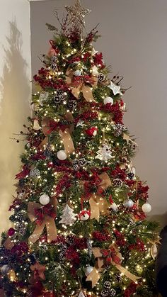 a decorated christmas tree with red, white and gold decorations