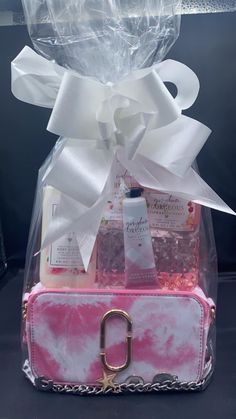 a pink and white bag with some items in it