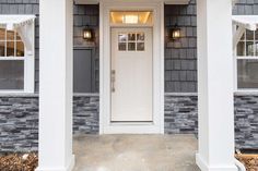 the front entrance to a house with white trim