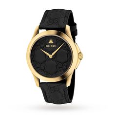 This elegant G-Timeless watch from Gucci showcases a black Gucci Signature leather dial set in a 38mm polished yellow-gold-tone PVD-finish stainless steel case, paired with a black Gucci Signature calf leather strap. A scratch-resistant sapphire crystal with antireflective coating tops the dial, while a yellow-gold-tone PVD-finish stainless steel buckle secures the strap. The watch features a Swiss quartz movement and is water-resistant to 50 meters. Gucci Watches For Men, Gucci Watches, Brown Leather Strap Watch, Timeless Watches, Mens Watches Leather, Gucci Mane, Gucci Watch, Gucci Jewelry, Leather Strap Watch