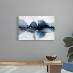 a painting hanging on the wall above a table with a bowl in front of it