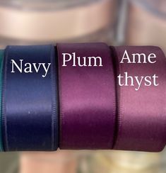 three rolls of purple and blue satin ribbon with the words navy plum, ame thyst