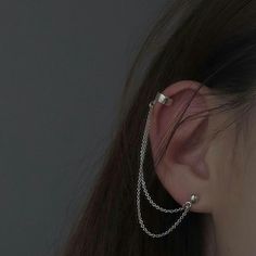 a close up of a person with ear piercings on their ears and behind them is a black background