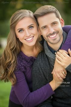 a man and woman are hugging each other