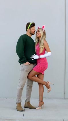 a man and woman dressed up in bunny ears posing for the camera with their arms around each other