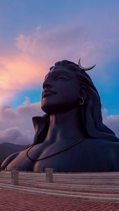 there is a large statue in front of the sky