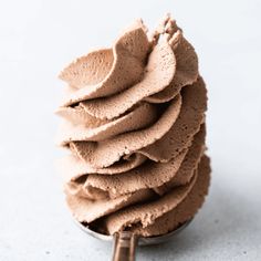 a scoop of chocolate frosting sitting on top of a table