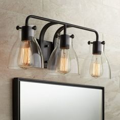 a bathroom vanity light with three bulbs on it