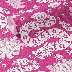 a roll of pink and white paper with floral designs on it