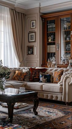 a living room filled with lots of furniture next to a tall bookcase full of books