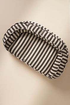 a black and white striped tray sitting on top of a table next to a wall