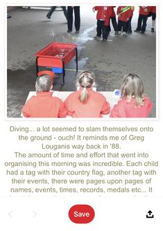 a group of children sitting at a table in front of a red box with water on it