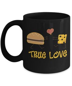 a black coffee mug that says true love with cheese and heart shaped balloons on it