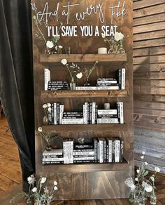 a wooden book shelf with flowers and books on it that says i'll save you a seat