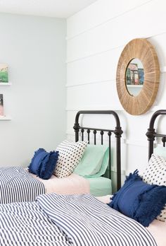 two twin beds with blue and white pillows